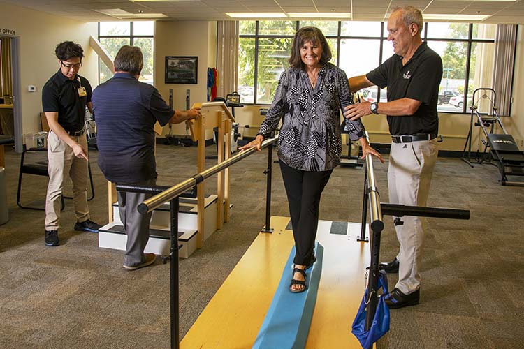 PT personal helping patient walking